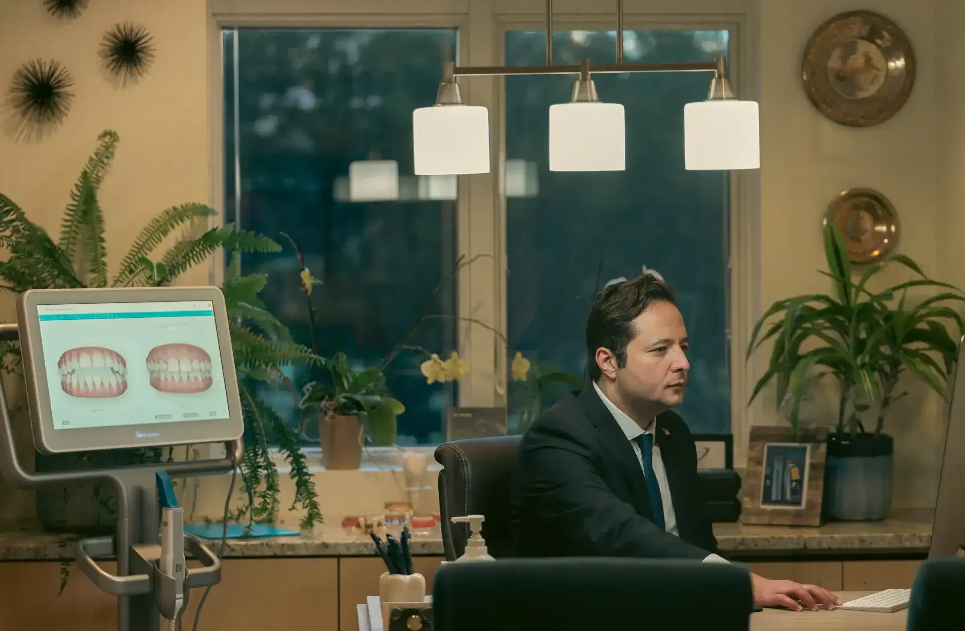 Dr. Tarek Badawy reviewing a digital scan at his desk in the Sterling office
