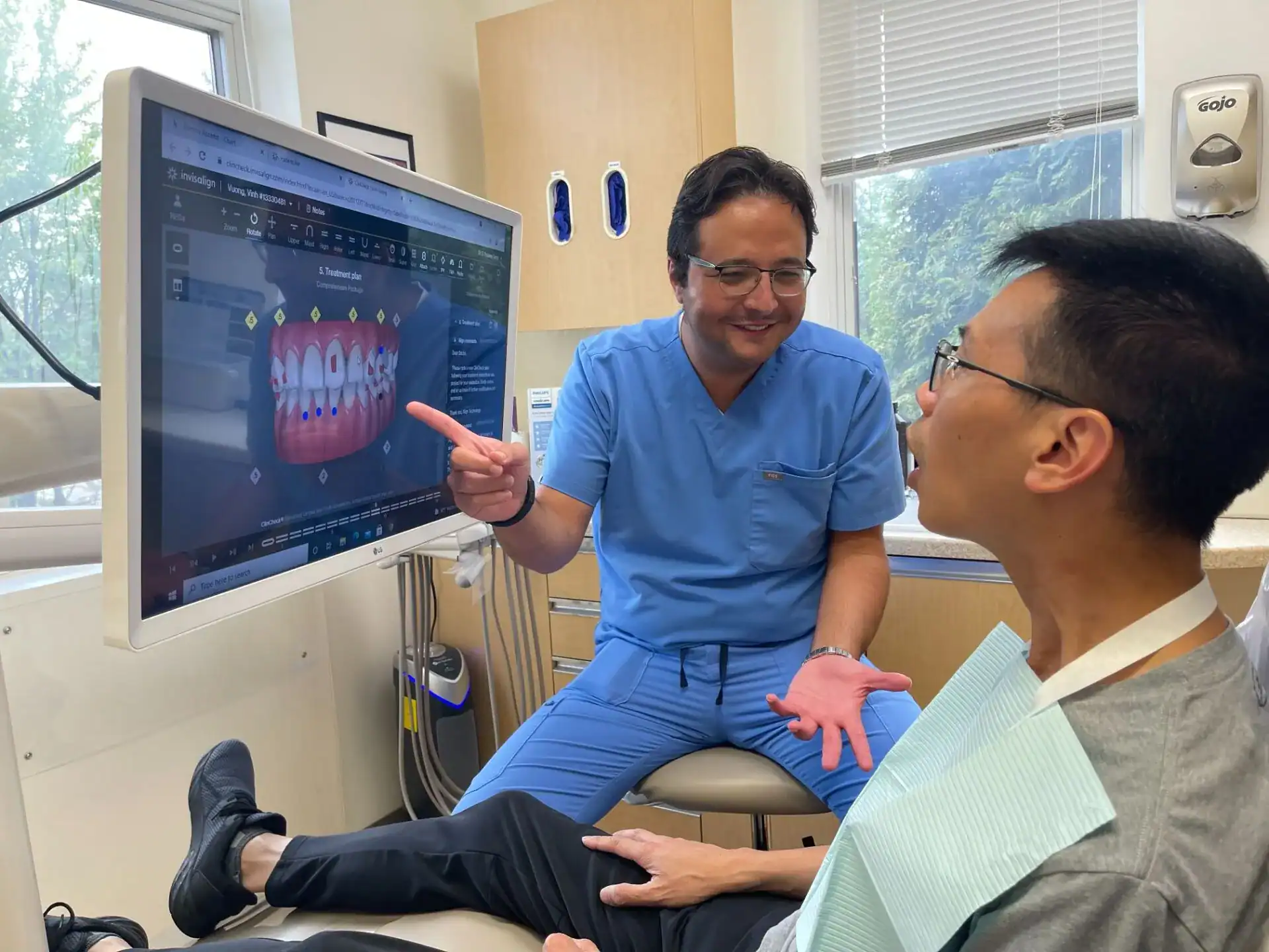 A Westlake dentist walking a guest through his Invisalign treatment plan on the chairside monitor