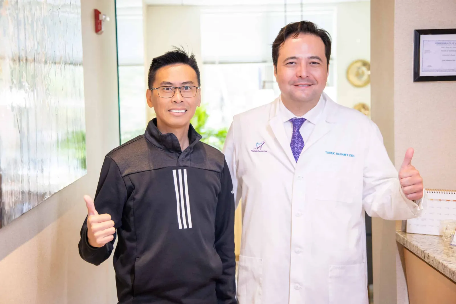 Dr. Tarek Badawy welcoming a guest at the Westlake Dental front desk