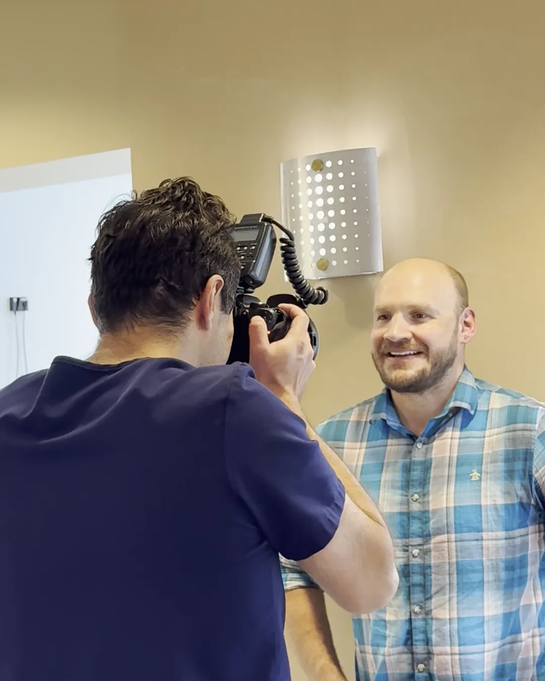 Dr. Tarek Badawy photographing a guest wearing the Smile Reveal mock-up at Westlake Dental Care